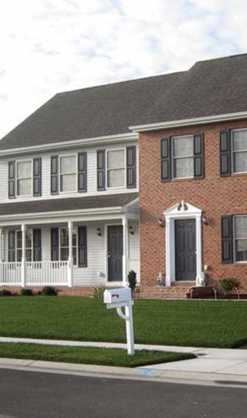 row of two story townhomes with brick and vinyl siding